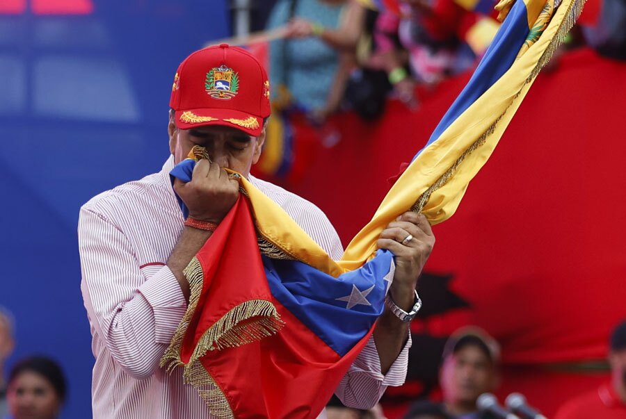 رئیس جمهوری ونزوئلا در جریان یک تظاهرات میهنی در کاراکاس پرچم کشورش را می بوسد./ گتی ایمجز